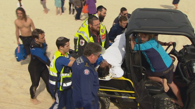 A student is treated by lifeguards and paramedics at Bondi Beach.