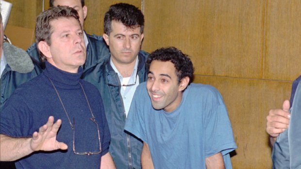 Yigal Amir smiles in a Tel Aviv court on  December 6, 1995, during a hearing in which murder charges were brought against him.