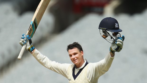 Victoria's Peter Handscomb celebrates after reaching his century on Sunday.