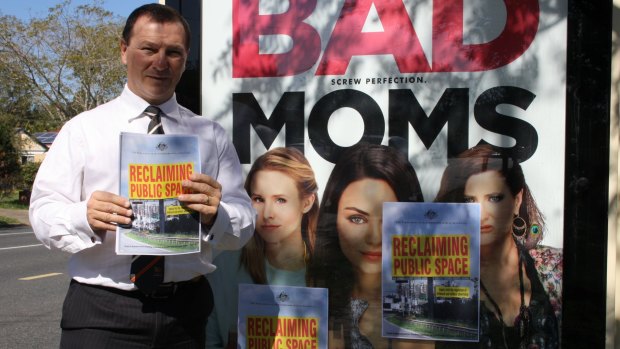 Member for Moreton Graham Perrett with the offending poster for Bad Moms.