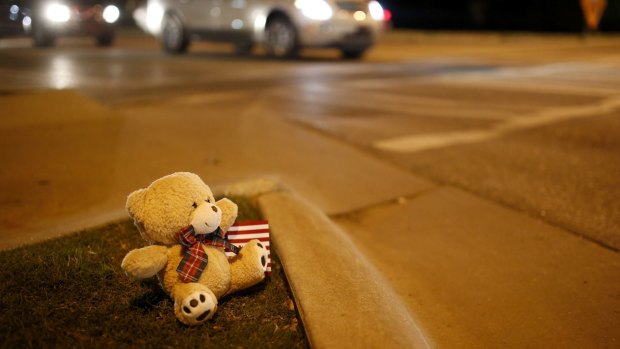 A teddy bear sits on the corner of Main and Hall of Fame in Stillwater to remember the dead and injured.