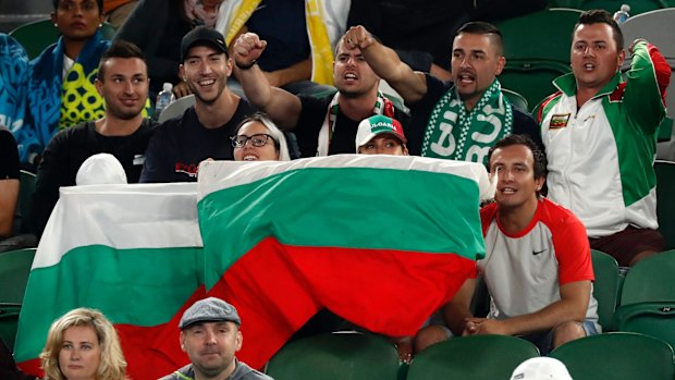 Supporters of Dimitrov cheer him.