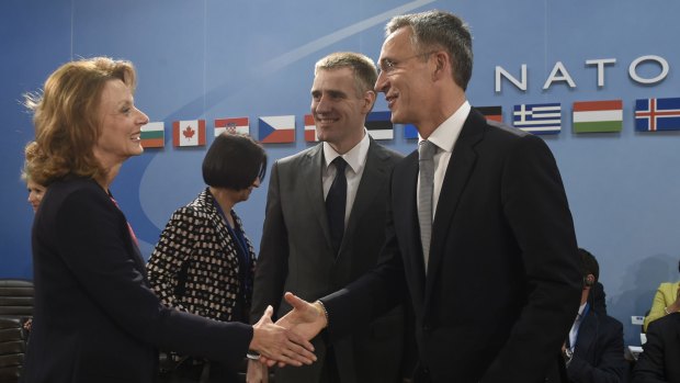 NATO Secretary-General Jens Stoltenberg (right) greets Montenegro's Foreign Minister Igor Luksic (centre), and Montenegro's Defence Minister Milica Pejanovic-Durisic.