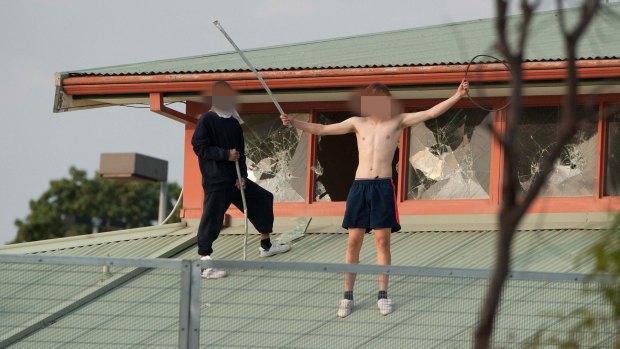 Youths protesting on the roof of the Melbourne Youth Justice Centre at Parkville in March.