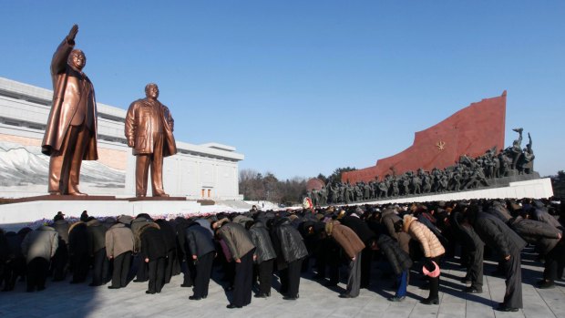 People bow to the bronze statues of their late leaders Kim Il Sung and Kim Jong Il at Mansu Hill, marking the sixth anniversary of leader Kim Jong Il's death in Pyongyang, North Korea.