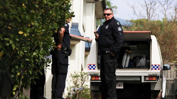 Police at the Bulimba townhouse after the woman was found.
