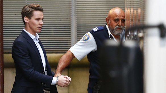 Insider trader Oliver Curtis is escorted to a prison truck after being sentenced to two years in jail.