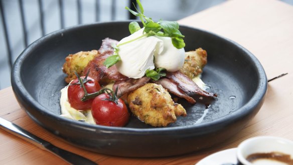 Enjoy a breakfast of zucchini and pea fritters with streaky bacon and poached eggs at Little Nel's in Port Stephens.