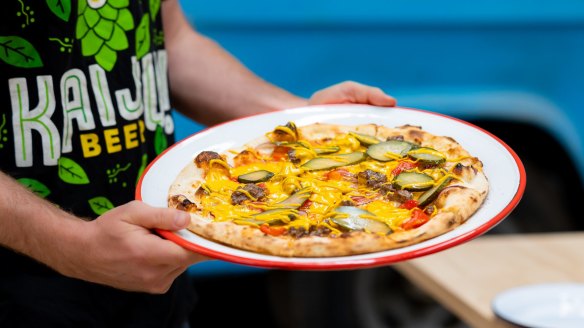 Cheeseburger pizza topped with San Marzano tomatoes, American cheese, red onion, beef mince, pickles and mustard.
