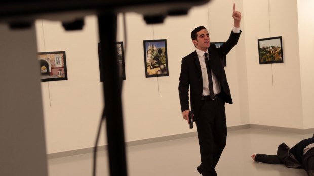 A man with a gun shouts inside the Ankara gallery as Russian ambassador to Turkey Andrei Karlov lies on the ground.