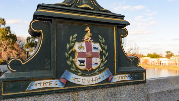 Melbourne's first coat of arms remains visible in the ornate lamp bases along Princes Bridge.