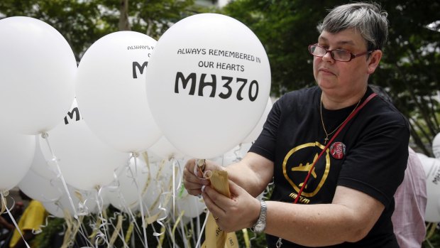Jacquita Gomes, wife of Patrick Gomes, the in-flight supervisor on MH370, prepares balloons with names of those on board during a remembrance event in Kuala Lumpur last week.