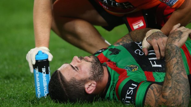 Another blow: Souths halfback Adam Reynolds receives attention after getting a heavy knock against Manly last month. 