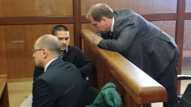 John Zakhariev, centre, speaks with his Australian lawyer Jay Williams, right, in court in Sophia on Friday April 7.