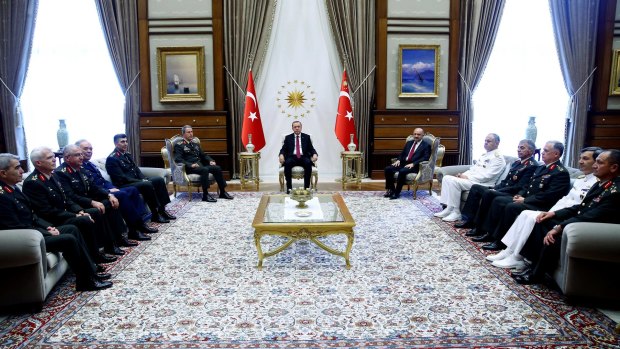 President Recep Tayyip Erdogan holds court with military chiefs during a meeting in Ankara on Friday.
