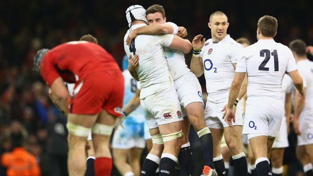Final whistle: England players celebrate as Wales are vanquished at home. 