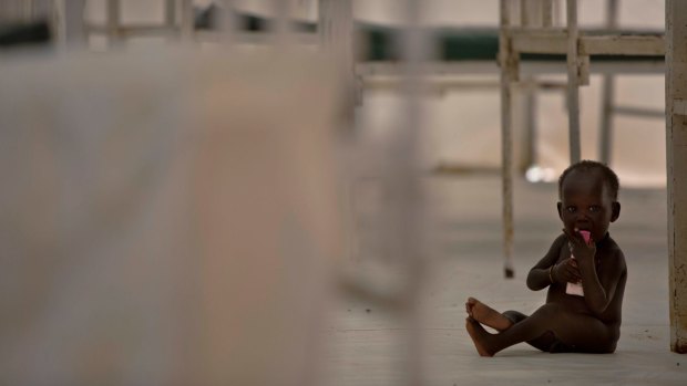 A young child sits on the floor in the therapeutic feeding unit of the Medecins Sans Frontieres hospital in the UN Protection of Civilians Camp in Bentiu, South Sudan. 