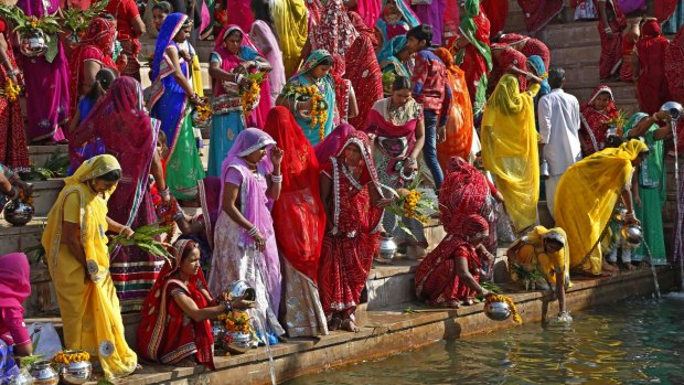 Hindu women collect water from the Pushkar lake to pour on idols of Lord Shiva during the Mahashivratri festival in Pushkar last week. India is officially secular, but four-fifths of the population is Hindu, while 14 per cent are Muslim.