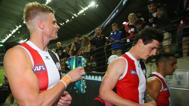 Encouraging: Jake Carlisle (right) leaves the ground with former skipper Nick Riewoldt on Thursday night.