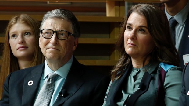 Bill Gates, left, and his wife, Melinda Gates, listen to former president Barack Obama speak during the Goalkeepers Conference.
