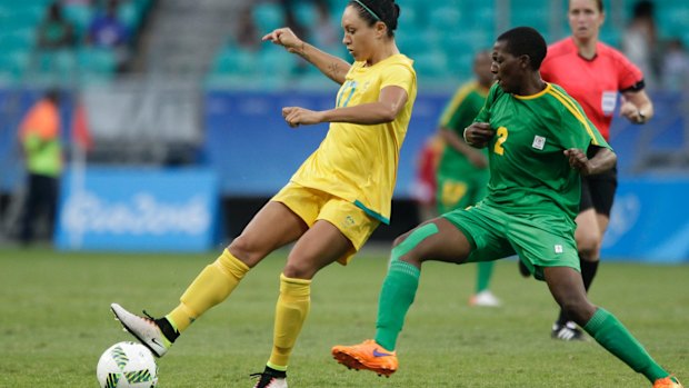 Kyah Simon, left, fights for the ball with Zimbabwe's Lynett Motokuto on Wednesday.