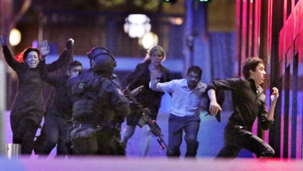 Hostages flee from Sydney's Lindt Chocolate Cafe in December.