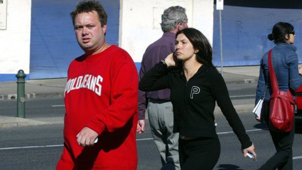 The late-Carl Williams arriving at a gangland murder in Carlton, with his then-wife Roberta Williams, in 2004.