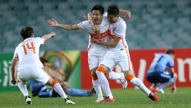 And the ecstasy: Shandong Luneng teammates celebrate their dramatic victory.