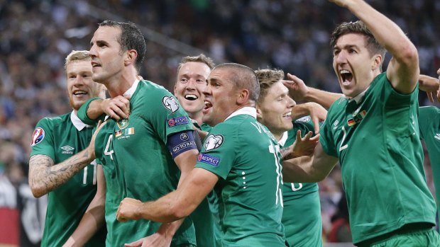 Ireland players surround John O'Shea after the centurion scored the equaliser.