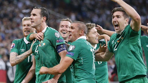 Ireland players surround John O'Shea after the centurion scored the equaliser.