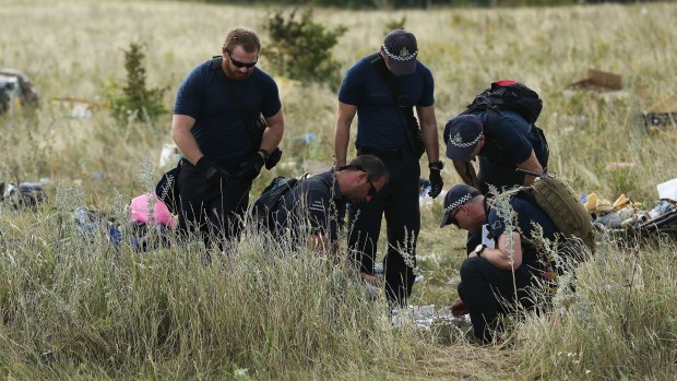 Australian Federal Police officers and their Dutch counterparts at the MH17 crash site in the fields outside the village of Grabovka in eastern Ukraine.