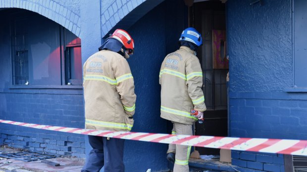 Firefighters enter the Russell Street building.