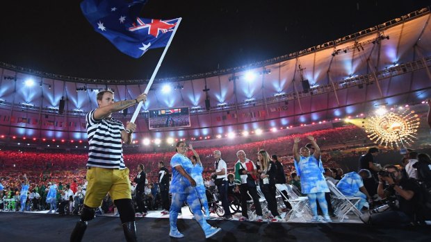 Gold medalist Curtis McGrath carries the flag for Australia during the closing ceremony of the Rio 2016 Paralympic Games at Maracana Stadium on Monday. 