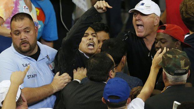 A man protests Donald Trump while he speaks during a campaign rally in Florida.