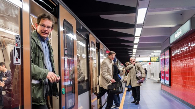 Commuters arrive at Maelbeek metro station in Brussels on April 2016 for the first time since the March 22 attacks.