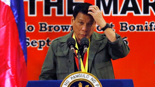 Philippine President Rodrigo Duterte scratches his head as he addresses marines in Taguig, east of Manila, on Tuesday.