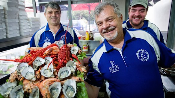 Kosta Tsapogas (left), Con Patsiotis and his son Theodore (right) show off a platter of premium Australian seafood at the Australian Seafood Fish and Chippery in North Coburg.