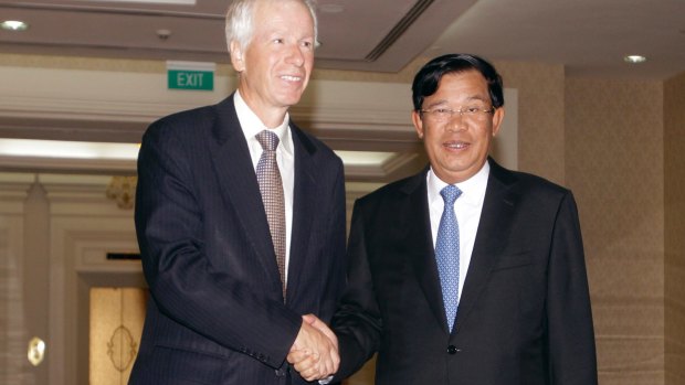 Cambodian Prime Minister Hun Sen, right, shakes hands with Canadian Foreign Minister Stephane Dion earlier this month.
