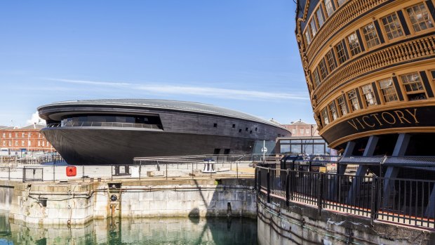 The museum building housing the Mary Rose with another famous warship, the HMS Victory, in the foreground.