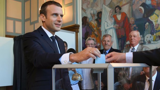 French President Emmanuel Macron casts his ballot in Le Touquet on Sunday.