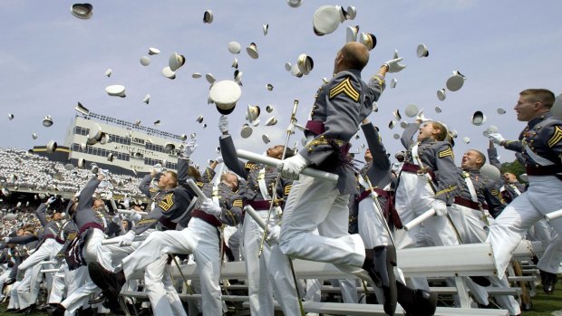 Hats off: Graduates toss their hats in the air after taking the oath of office and graduating from the US Military Academy.