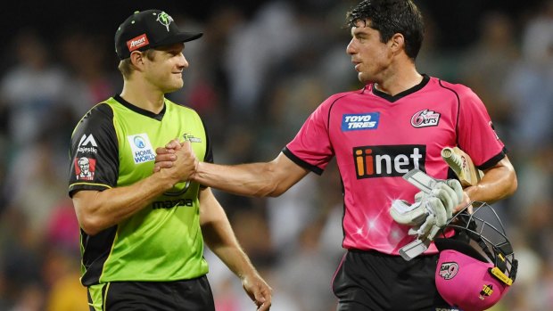 Shane Watson, of the Thunder, congratulates Moises Henriques after the Sixers claimed a thrilling victory at the SCG on Saturday night.