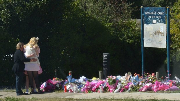 The site of Masa Vukotic's murder in Doncaster covered in pink flowers on Friday.