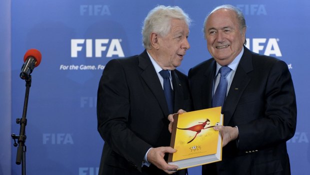Frank Lowy presents Sepp Blatter with the official bid document in 2010. 
