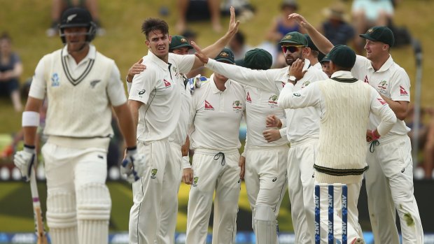 All-round drubbing: Mitch Marsh celebrates the wicket of Corey Anderson on day four of the Wellington Test.
