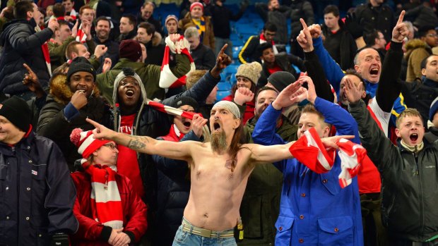Arsenal fans celebrate their away win over title favourites Manchester City on Sunday.