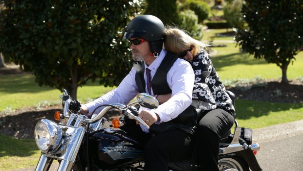 Hannah's parents, Lance and Rachael Rye, ride on a motorbike as part of a procession of hundreds.