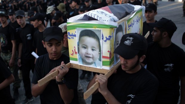 Palestinian youths carry a mock coffin of Ali Dawabshe in the Gaza Strip town of Khan Younis.