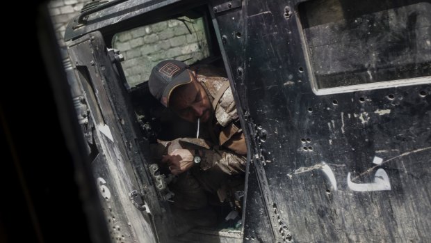 A soldier with the Iraqi special forces reverses a humvee inside the city of Mosul where fighting between Iraqi forces and the Islamic State group continues.