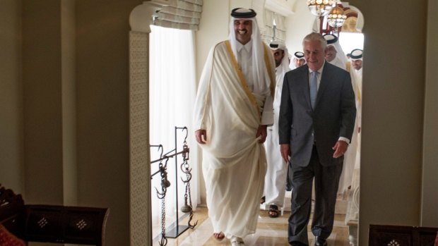 The Emir of Qatar, Sheikh Tamim Bin Hamad Al Thani, left, welcomes US Secretary of State Rex Tillerson to Sea Palace, his official residence, in Doha on Tuesday.